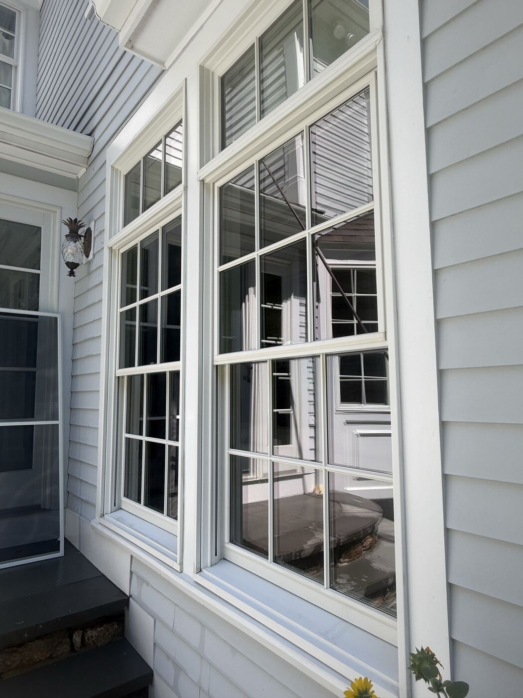 Double-hung windows with the screens removed for cleaning