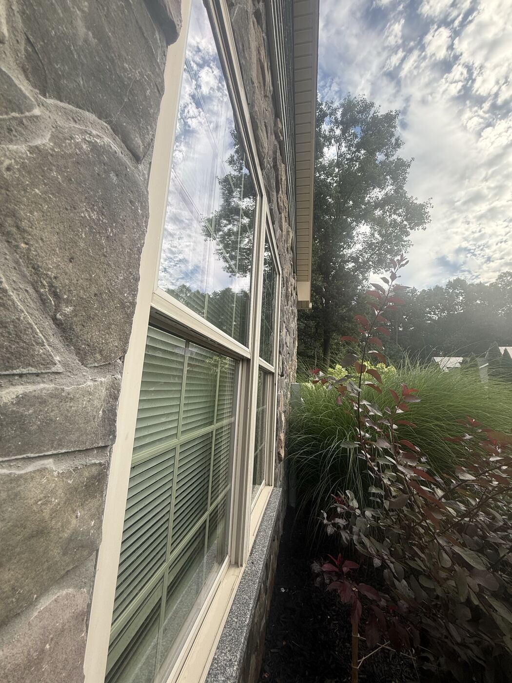 Clean windows on a stone-faced home