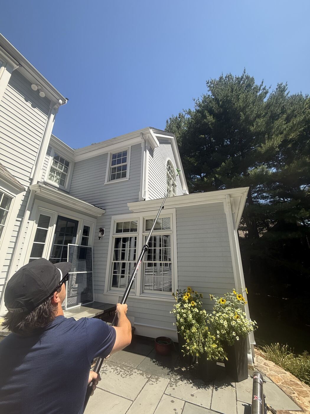 Reaching a dormer window with an extension pole